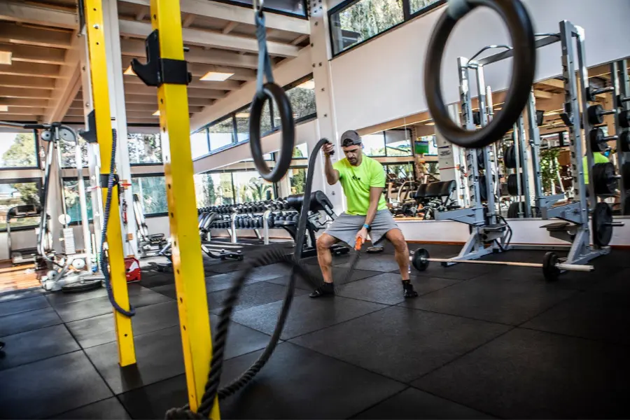 Allenamento funzionale in palestra con corde e attrezzi per migliorare forza e resistenza